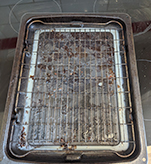 Dirty oven tray before oven cleaning